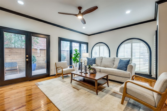 living room with french doors, ceiling fan, ornamental molding, and light hardwood / wood-style floors