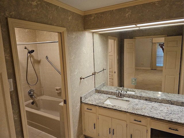 bathroom with ornamental molding, vanity, tiled shower / bath combo, and tile patterned floors