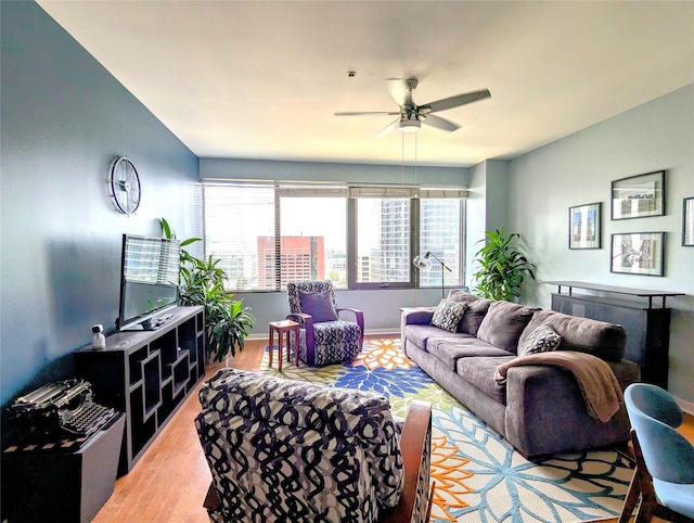 living room with ceiling fan and light wood-type flooring