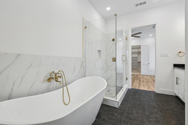 3703 Pilgrims Mews, Rowlett, TX 75088 - bathroom with vanity, a marble finish shower, a soaking tub, a walk in closet, and tile patterned flooring