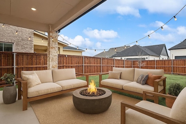 3703 Pilgrims Mews, Rowlett, TX 75088 - fenced backyard featuring an outdoor living space with a fire pit and a patio area