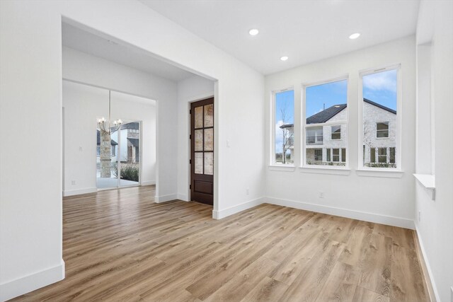 3703 Pilgrims Mews, Rowlett, TX 75088 - unfurnished room featuring light wood-style floors, a chandelier, and recessed lighting