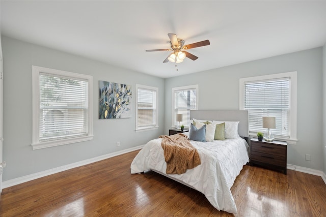 bedroom with dark hardwood / wood-style floors and ceiling fan