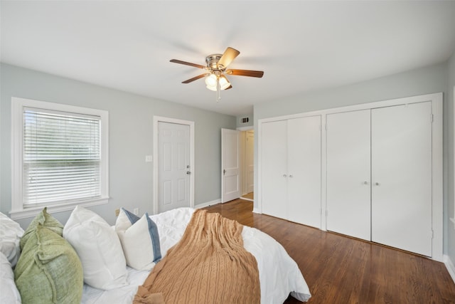 bedroom with ceiling fan and dark hardwood / wood-style floors