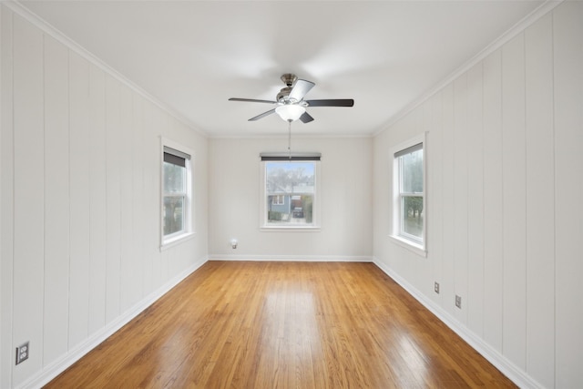 spare room featuring hardwood / wood-style floors, crown molding, and ceiling fan