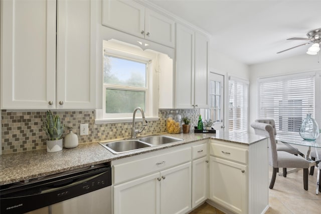 kitchen with white cabinetry, dishwasher, sink, and backsplash