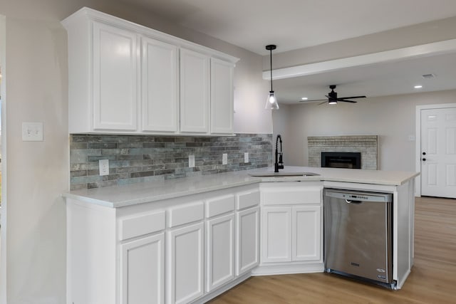 kitchen with sink, white cabinets, dishwasher, and light wood-type flooring