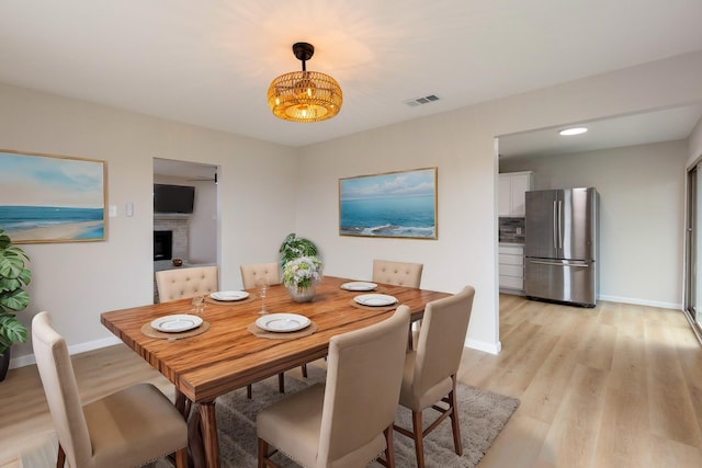 dining area with light hardwood / wood-style floors