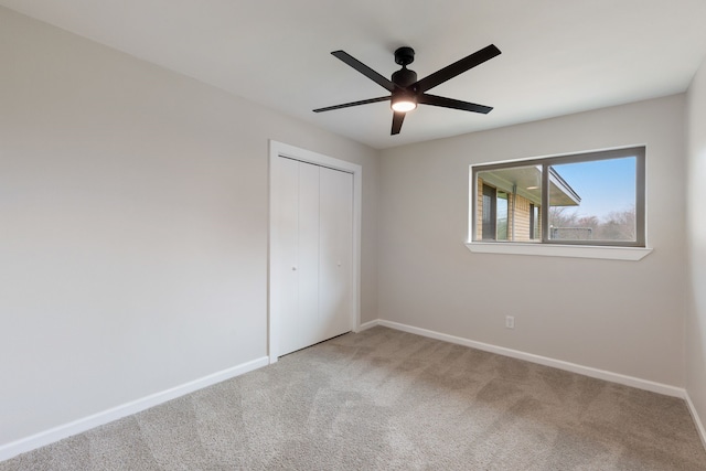 unfurnished bedroom with a closet, ceiling fan, and carpet