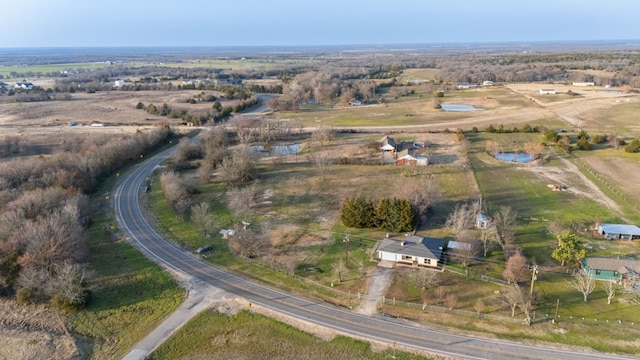 birds eye view of property with a water view and a rural view