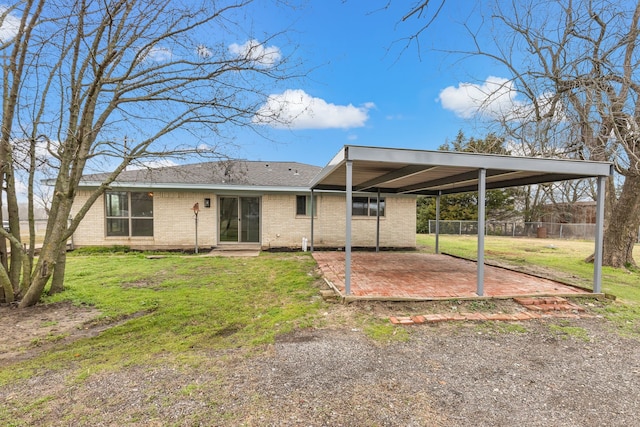 rear view of property with a yard