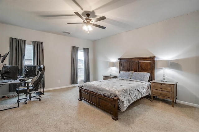 carpeted bedroom featuring multiple windows and ceiling fan