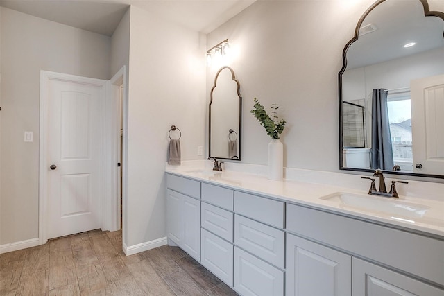 bathroom with hardwood / wood-style flooring and vanity