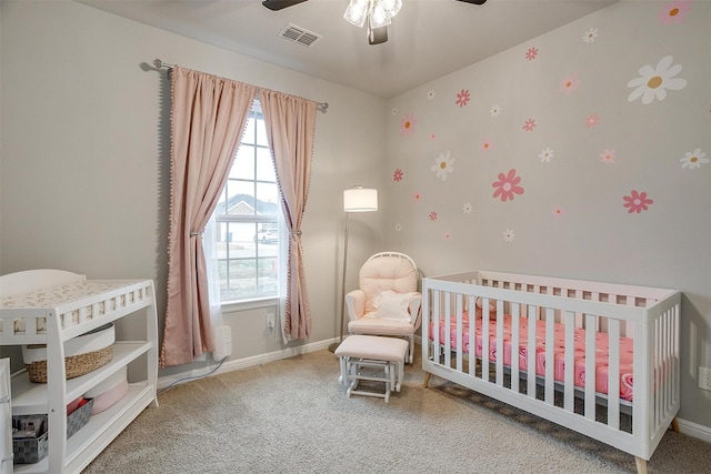 carpeted bedroom with a nursery area and ceiling fan