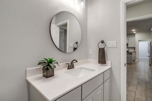 bathroom with vanity and hardwood / wood-style floors