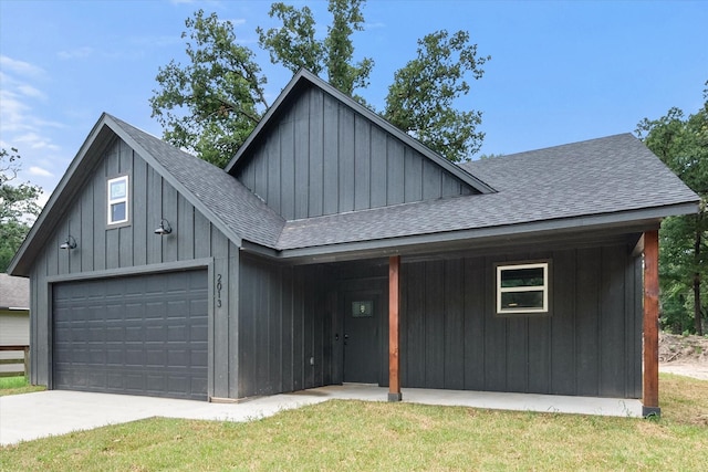 view of front of house with a garage and a front lawn