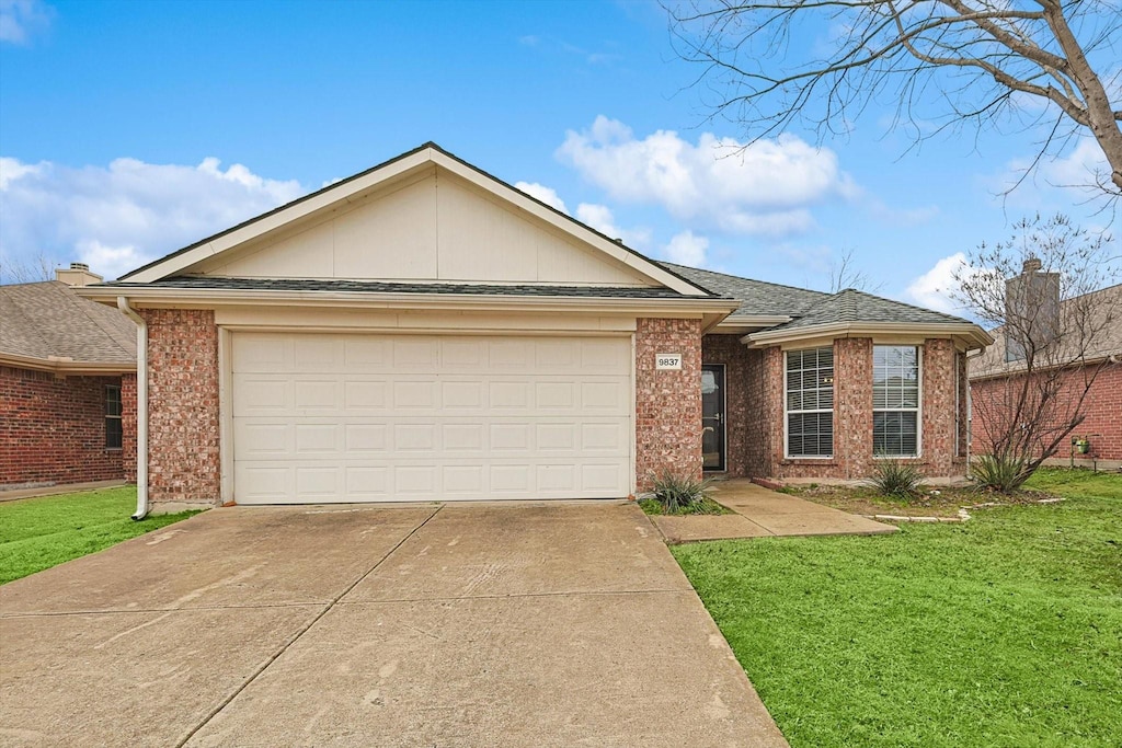 single story home featuring a garage and a front yard