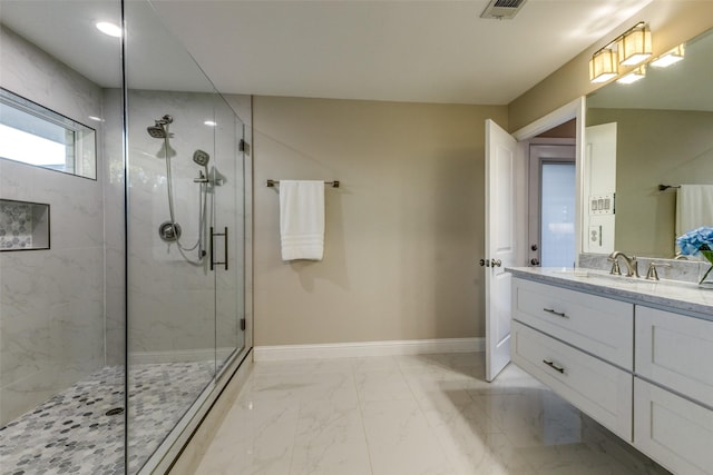 full bathroom featuring marble finish floor, a marble finish shower, visible vents, vanity, and baseboards