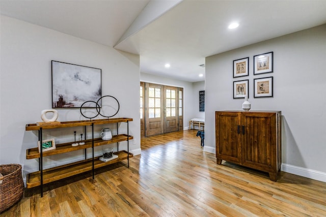 interior space featuring recessed lighting, light wood-style flooring, baseboards, and french doors