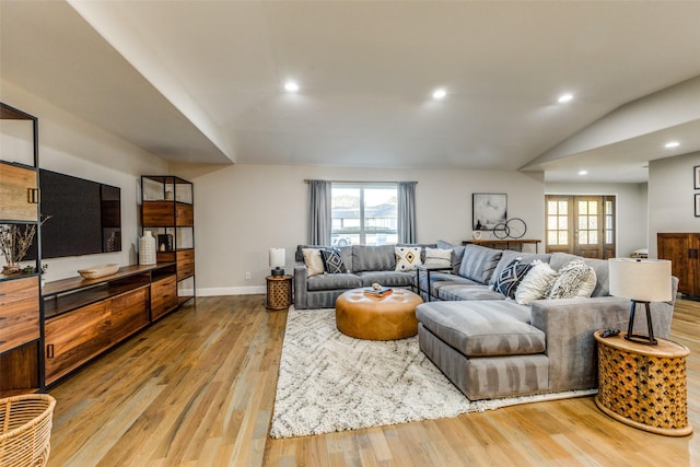 living room with baseboards, vaulted ceiling, wood finished floors, and recessed lighting