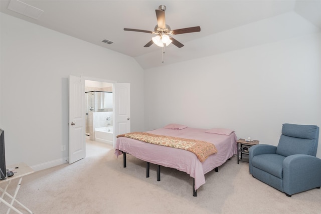 carpeted bedroom featuring ensuite bathroom, lofted ceiling, and ceiling fan