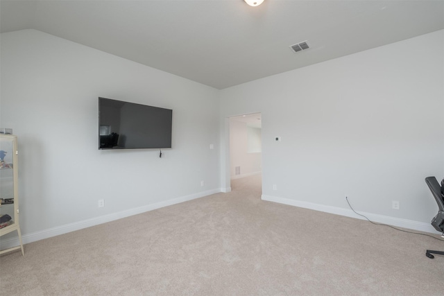 unfurnished office featuring lofted ceiling and light carpet