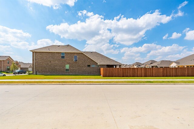 view of side of home featuring a lawn