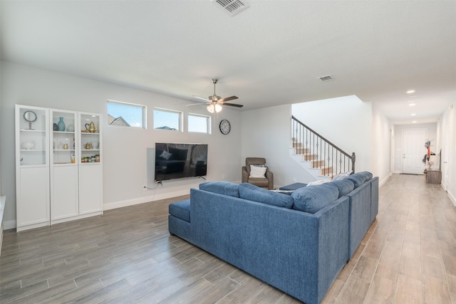 living room with hardwood / wood-style floors and ceiling fan