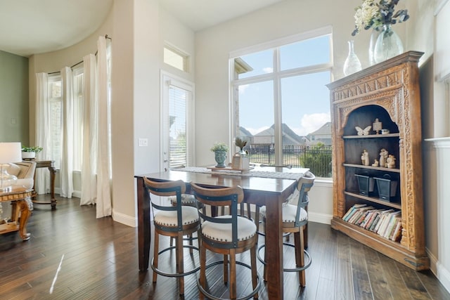 dining space with dark hardwood / wood-style flooring