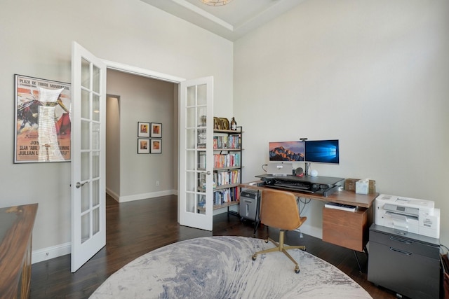 home office with dark hardwood / wood-style floors and french doors