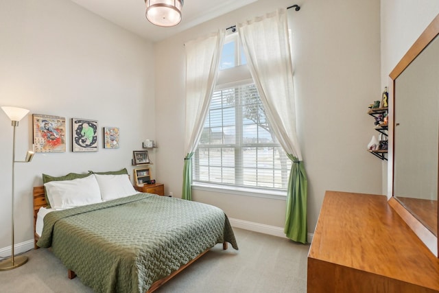 carpeted bedroom with multiple windows