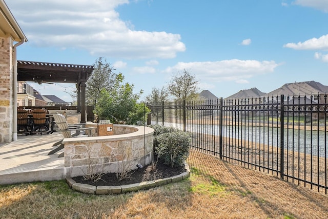 view of yard featuring a patio, a water view, and area for grilling