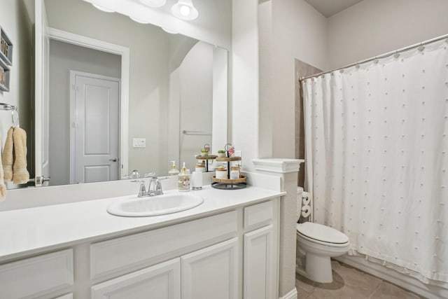 full bathroom with vanity, tile patterned floors, toilet, and shower / bath combo with shower curtain