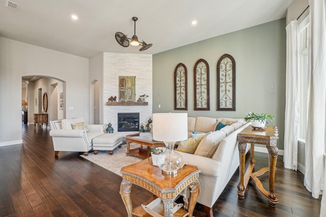 living room featuring a fireplace and dark hardwood / wood-style floors