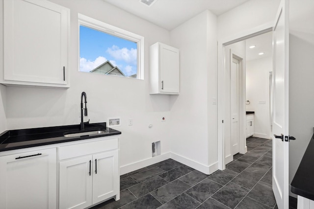 washroom with sink, cabinets, hookup for a gas dryer, washer hookup, and electric dryer hookup