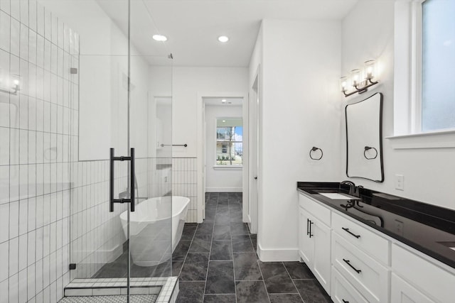 bathroom with vanity and separate shower and tub