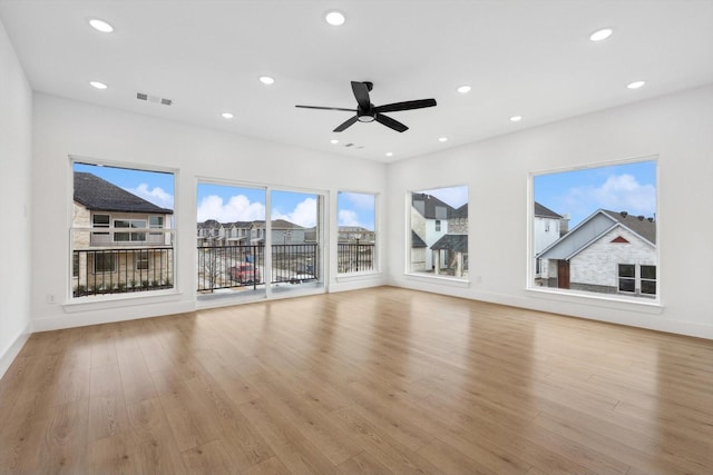 unfurnished living room featuring ceiling fan and light wood-type flooring