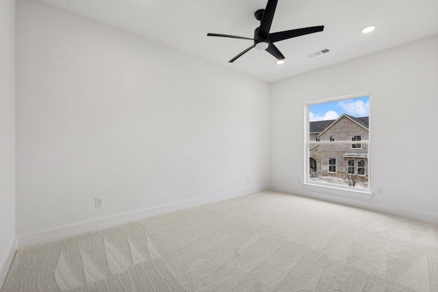 empty room featuring ceiling fan and carpet