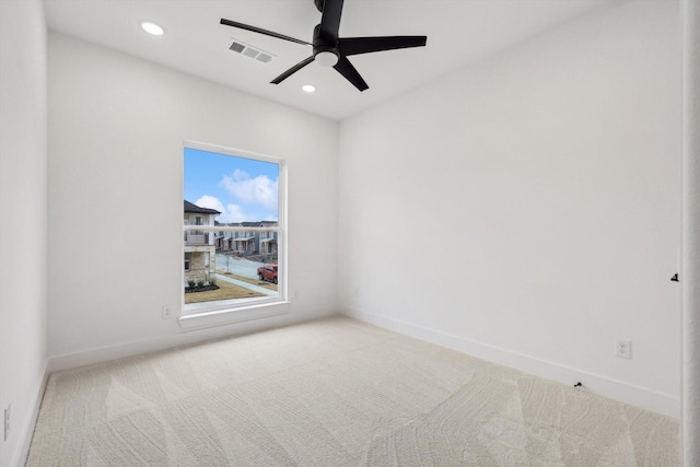 carpeted empty room featuring ceiling fan