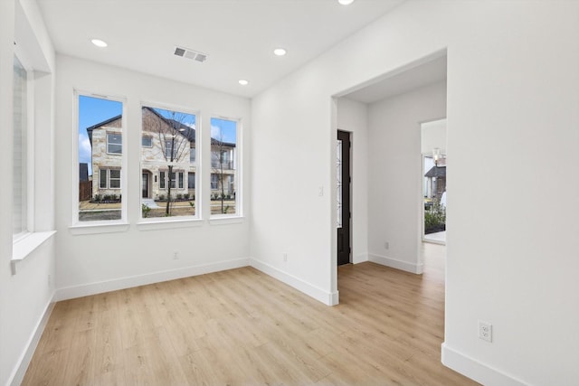 empty room featuring a healthy amount of sunlight and light wood-type flooring