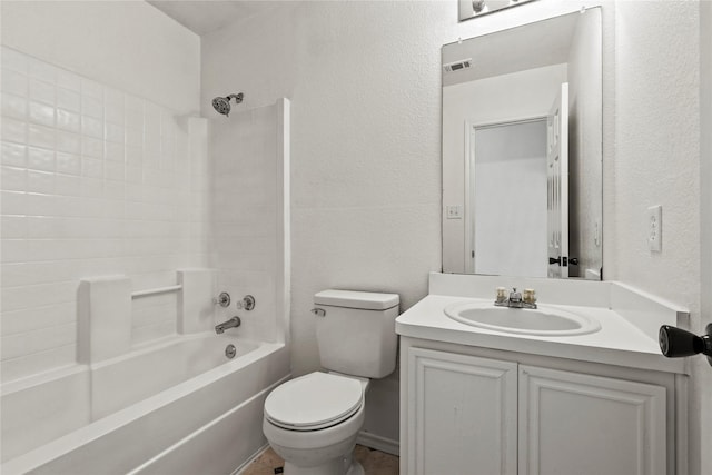 full bathroom featuring washtub / shower combination, vanity, and toilet