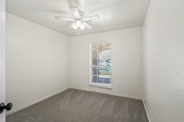 unfurnished room featuring ceiling fan and carpet