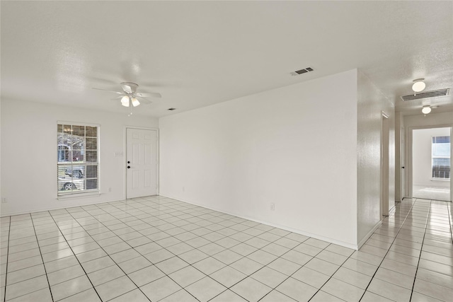 tiled empty room with ceiling fan