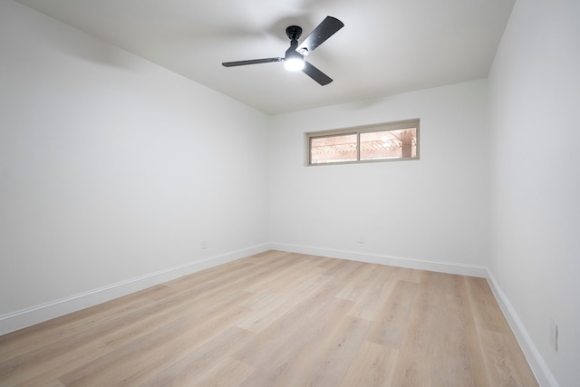 unfurnished room featuring ceiling fan, light wood-style flooring, and baseboards