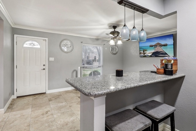 kitchen with a breakfast bar, decorative light fixtures, kitchen peninsula, crown molding, and light stone countertops