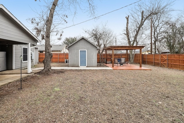 view of yard with a storage unit and a patio