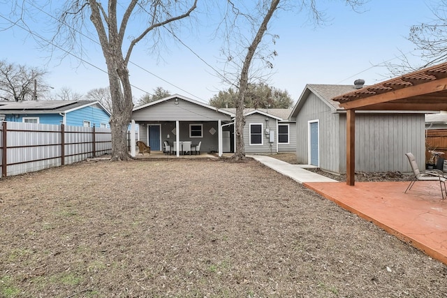 back of property with a pergola and a patio area