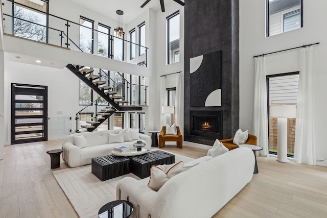 living room featuring a wealth of natural light, a fireplace, and light hardwood / wood-style flooring