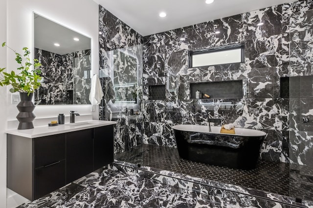 bathroom with vanity and a tub to relax in