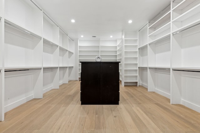 walk in closet featuring light hardwood / wood-style flooring